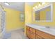 Bathroom featuring a bathtub/shower and a vanity with wood cabinets and a large mirror at 410 W Tenth St, Siler City, NC 27344
