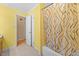 Bright bathroom with a bathtub/shower with stylish curtain, a separate toilet room, and vanity at 410 W Tenth St, Siler City, NC 27344