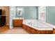 The main bathroom has a bathtub with tile flooring and a wooden vanity at 410 W Tenth St, Siler City, NC 27344