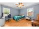 Bedroom with a ceiling fan, light hardwood floors and a desk that's perfect for a home office at 410 W Tenth St, Siler City, NC 27344