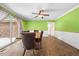 Bright dining room features beadboard detail, glass sliding door, and modern ceiling fan at 410 W Tenth St, Siler City, NC 27344