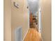 Hallway connects main area to kitchen with hardwood floors, neutral paint, and modern finishes at 410 W Tenth St, Siler City, NC 27344