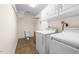 Convenient laundry room with storage cabinets, washer, dryer, and utility sink at 410 W Tenth St, Siler City, NC 27344