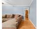 Hardwood floors in a cozy living room featuring a comfortable sofa and neutral decor at 410 W Tenth St, Siler City, NC 27344