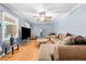 Comfortable living room featuring a ceiling fan, hardwood floors, and natural light at 410 W Tenth St, Siler City, NC 27344