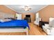 Spacious main bedroom has neutral walls, ceiling fan, and hardwood floors at 410 W Tenth St, Siler City, NC 27344