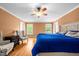 Spacious main bedroom has neutral walls, ceiling fan, and hardwood floors at 410 W Tenth St, Siler City, NC 27344
