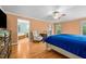 Spacious main bedroom has neutral walls, ceiling fan, and adjoins main bathroom at 410 W Tenth St, Siler City, NC 27344
