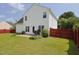 Expansive backyard showcasing a well-maintained lawn and privacy fence at 412 Onondaga Ct, Holly Springs, NC 27540