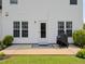 Home's backyard featuring a patio, well-maintained lawn, and lush landscaping at 412 Onondaga Ct, Holly Springs, NC 27540