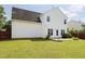 Large backyard featuring a lush lawn, privacy fence, and mature trees at 412 Onondaga Ct, Holly Springs, NC 27540