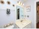 Well-lit bathroom with updated fixtures, decorative mirror, and white vanity at 412 Onondaga Ct, Holly Springs, NC 27540