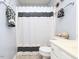 Bright bathroom with white vanity, decorative mirror, and stylish black and white shower curtain at 412 Onondaga Ct, Holly Springs, NC 27540