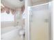 Well-lit bathroom featuring a combined tub and shower with frosted glass door at 412 Onondaga Ct, Holly Springs, NC 27540