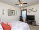 Charming bedroom features a ceiling fan, large window, stylish decor, and comfortable chair at 412 Onondaga Ct, Holly Springs, NC 27540