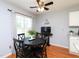Cozy dining area with black table and chairs complemented by natural light from the window at 412 Onondaga Ct, Holly Springs, NC 27540