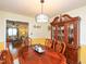 Elegant dining room with classic hutch and a large wooden table with seating for six at 412 Onondaga Ct, Holly Springs, NC 27540