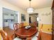 Bright dining room with hardwood floors and a view of the kitchen and living areas at 412 Onondaga Ct, Holly Springs, NC 27540