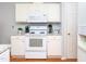 Clean and functional kitchen with white cabinets and appliances, maximizing space and efficiency at 412 Onondaga Ct, Holly Springs, NC 27540
