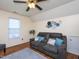 Cozy living room featuring a comfortable gray sofa with decorative pillows and hardwood floors at 412 Onondaga Ct, Holly Springs, NC 27540