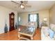 Inviting living room with hardwood floors and a grand clock near the entry at 412 Onondaga Ct, Holly Springs, NC 27540