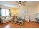 Bright living room featuring hardwood floors, lots of light and a ceiling fan at 412 Onondaga Ct, Holly Springs, NC 27540