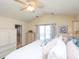Bright bedroom featuring a large window and a neutral palette leading into the en suite bathroom at 412 Onondaga Ct, Holly Springs, NC 27540