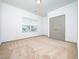 Clean bedroom featuring neutral carpet, double door closet, and a window with neighborhood view at 425 Sunny Field Dr., Wake Forest, NC 27587