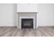 Close-up of the modern fireplace with a marble surround and hardwood flooring at 425 Sunny Field Dr., Wake Forest, NC 27587