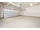 Spacious two car garage featuring a new garage door, concrete floor and painted drywall at 425 Sunny Field Dr., Wake Forest, NC 27587