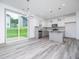 Modern kitchen and dining area with stainless steel appliances and sliding glass doors at 425 Sunny Field Dr., Wake Forest, NC 27587