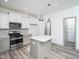 Well-lit kitchen with stainless appliances, light grey cabinets, and a center island at 425 Sunny Field Dr., Wake Forest, NC 27587