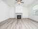 Elegant living room with hardwood floors, a ceiling fan, and a modern fireplace at 425 Sunny Field Dr., Wake Forest, NC 27587