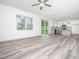 Open-concept living room flowing into kitchen with hardwood floors and lots of natural light at 425 Sunny Field Dr., Wake Forest, NC 27587