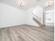 Bright living room featuring beautiful wood-look floors and a staircase at 425 Sunny Field Dr., Wake Forest, NC 27587