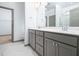 Bathroom features double vanity, sleek cabinets, and tiled floor at 425 Sunny Field Dr., Wake Forest, NC 27587