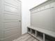 Well-organized mudroom features built-in bench seating with storage and convenient coat hooks at 425 Sunny Field Dr., Wake Forest, NC 27587