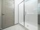 Modern tiled shower with glass door in a well-lit bathroom at 425 Sunny Field Dr., Wake Forest, NC 27587