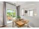 Bright dining area with a sliding glass door, patio view and table setting for four at 4524 Drewbridge Way, Raleigh, NC 27604