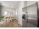 Bright dining area with tile flooring, an arched opening, and stainless steel refrigerator at 4524 Drewbridge Way, Raleigh, NC 27604