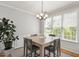 Well-lit dining room featuring a square table, traditional chandelier, and large windows at 4524 Drewbridge Way, Raleigh, NC 27604