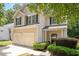 Charming two-story home boasts a two-car garage and classic curb appeal with lush landscaping and a welcoming entrance at 4524 Drewbridge Way, Raleigh, NC 27604