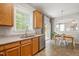 Sunlit kitchen area with granite counters, stainless steel appliances, and a view of the dining area and backyard at 4524 Drewbridge Way, Raleigh, NC 27604