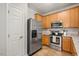 Functional kitchen with stainless steel appliances, wood cabinets, and ample storage, with a convenient refrigerator and pantry at 4524 Drewbridge Way, Raleigh, NC 27604