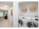 Functional laundry closet with new washer and dryer units, and plenty of shelf storage at 4524 Drewbridge Way, Raleigh, NC 27604