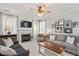 Inviting living room with a fireplace, TV, and a collection of tastefully framed pictures adds to the space's charm at 4524 Drewbridge Way, Raleigh, NC 27604