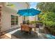 Outdoor patio featuring a dining set with an umbrella for shade at 4524 Drewbridge Way, Raleigh, NC 27604