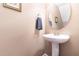 Powder room featuring a pedestal sink, decorative mirror, and neutral wall color at 4732 Altha St, Raleigh, NC 27606