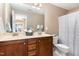 Bathroom with double vanity sinks, dark cabinets and white patterned shower curtain at 4732 Altha St, Raleigh, NC 27606