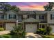 Charming townhome featuring a two-car garage, stone accents, and lovely landscaping at 4732 Altha St, Raleigh, NC 27606